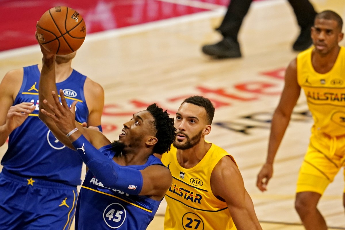 Donovan Mitchell (45) scores a layup over Jazz teammate Rudy Gobert (27)